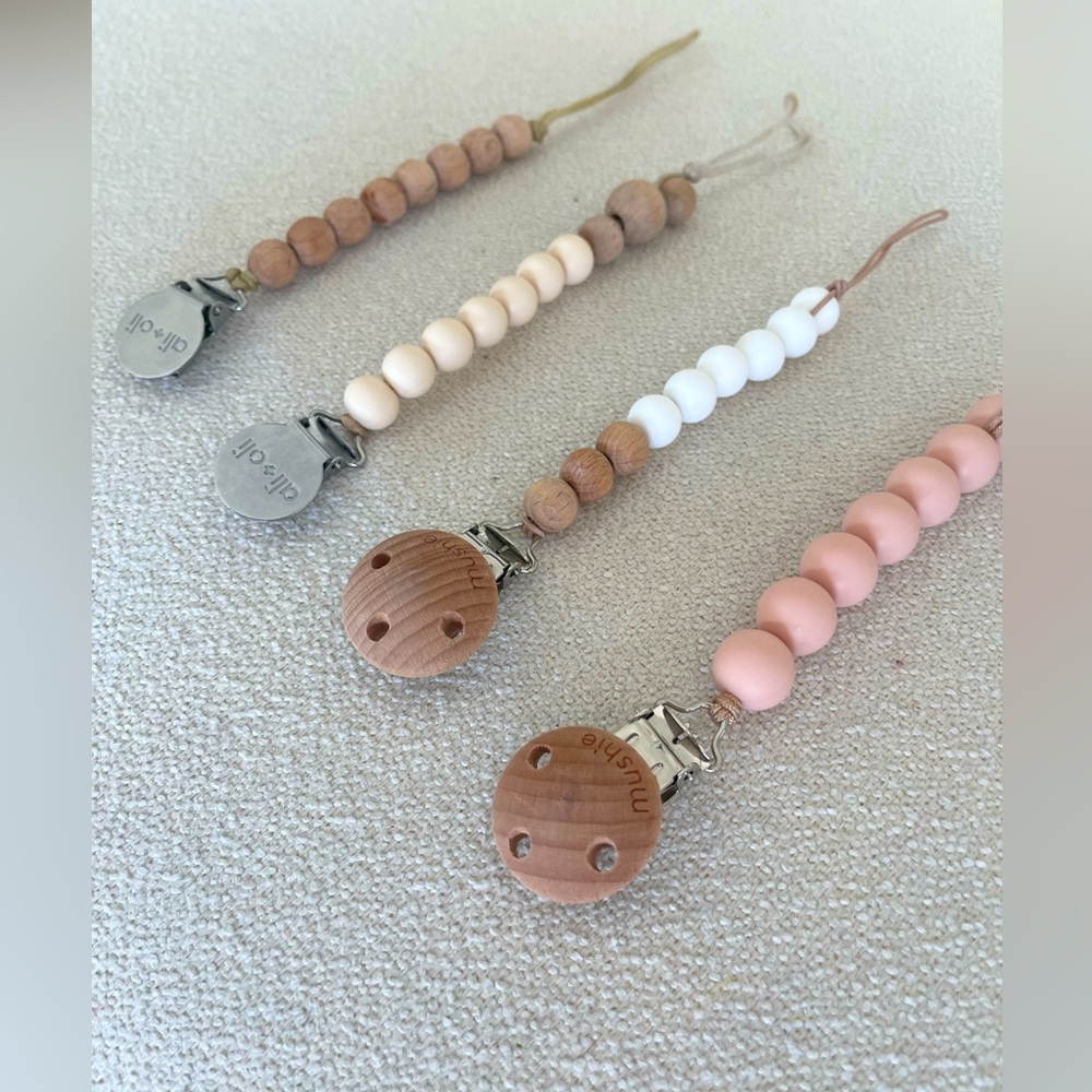 Four pacifier clip holders (mushie and Ali + oli)